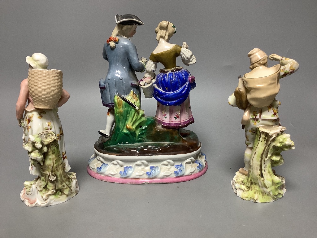 A Continental porcelain group of a couple picking flowers and a similar pair of figures